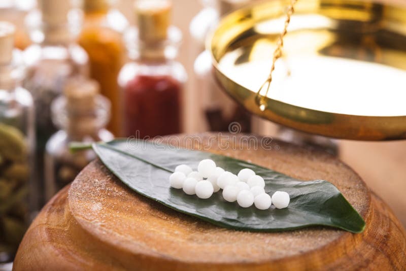 Homeopathy pills on the green leaf closeup. Green herbal drug medicine stock images, royalty-free photos and pictures