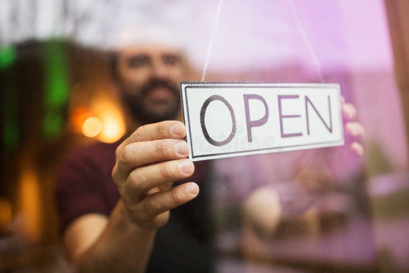 Homme avec la bannière ouverte à la fenêtre de barre ou de restaurant photo libre de droits Homme avec la bannière ouverte à la fenêtre de barre ou de restaurant photo libre de droits
