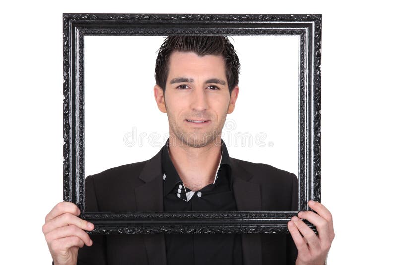 Homme avec le cadre de tableau photographie stock Homme avec le cadre de tableau photographie stock