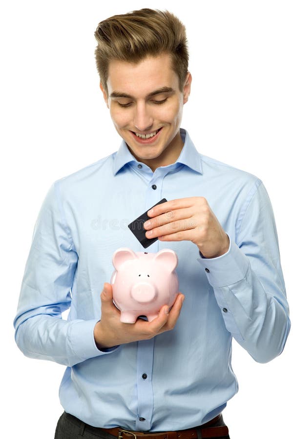 Homme avec le piggybank et par la carte de crédit photo stock Homme avec le piggybank et par la carte de crédit photo stock