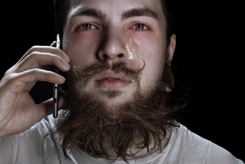 Crying Bearded Man Holding A Smartphone Near Your Ear. Crying Bearded Man Holding A Smartphone Near Your Ear