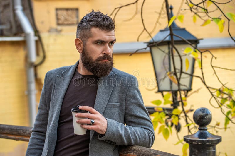Homme beau dans la rue tenant une tasse de café. Séparation du mode de vie des entreprises. Homme qui boit du café du matin. Pause photos libres de droits