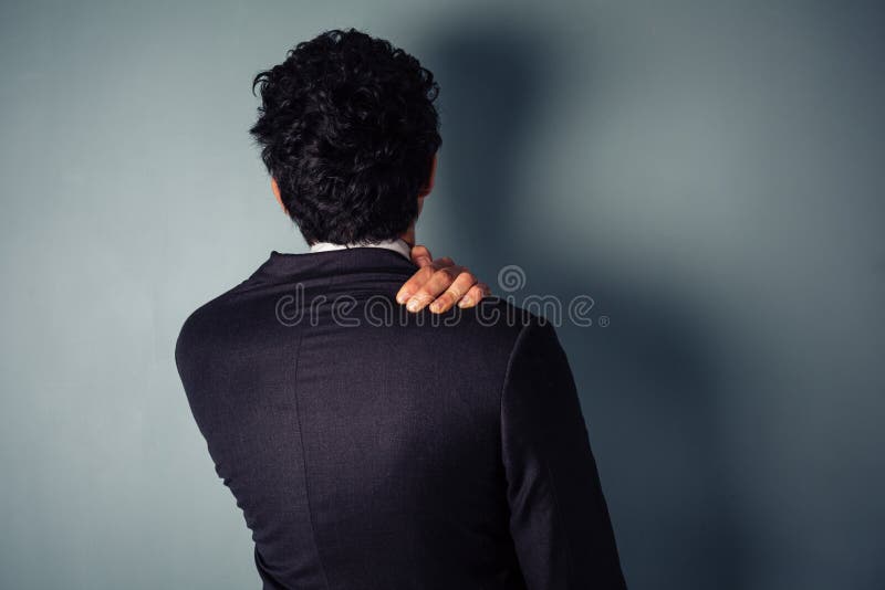 Homme d'affaires avec le cou endolori photographie stock libre de droits Homme d'affaires avec le cou endolori photographie stock libre de droits