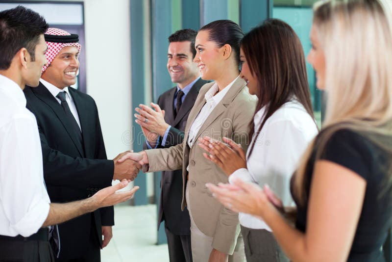 Young translator introducing arab businessman to group of businesspeople. Young translator introducing arab businessman to group of businesspeople