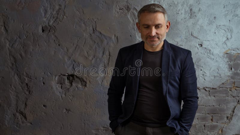 Homme d'affaires frais avec la position grise de cheveux et de barbe sur le fond gris photos libres de droits Homme d'affaires frais avec la position grise de cheveux et de barbe sur le fond gris photos libres de droits
