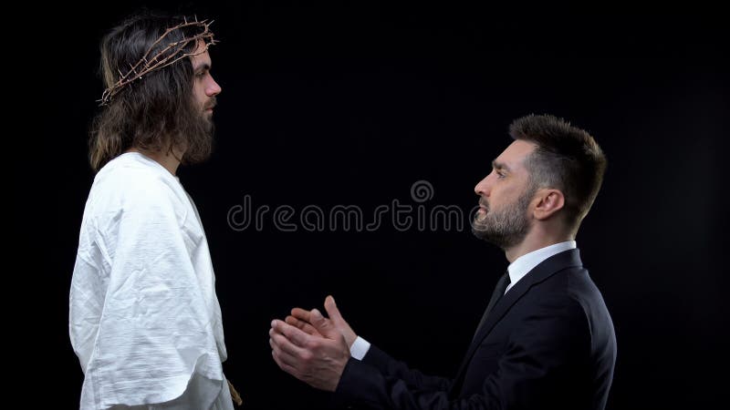 Homme d'affaires mâle agenouillé devant Jésus louant Dieu, demandant pardon photos stock