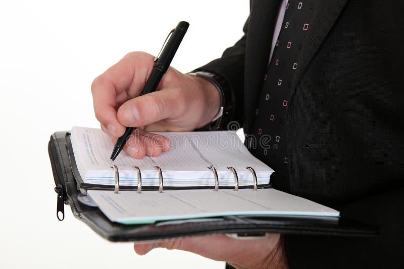 Homme d'affaires notant en bas du rendez-vous images stock