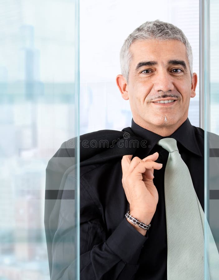 Closeup portrait of casual businessman standing in front of windows, smiling. Closeup portrait of casual businessman standing in front of windows, smiling.