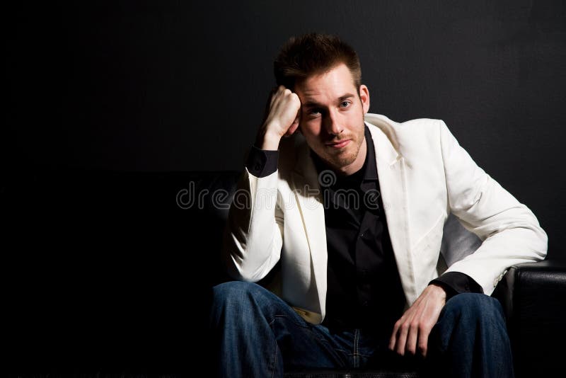 A portrait of a casual businessman sitting on a couch. A portrait of a casual businessman sitting on a couch