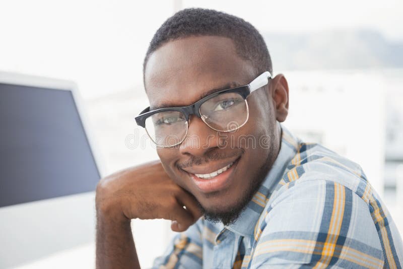 Casual businessman with glasses smiling in the office. Casual businessman with glasses smiling in the office