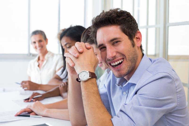 Casual businessman laughing during meeting in the office. Casual businessman laughing during meeting in the office