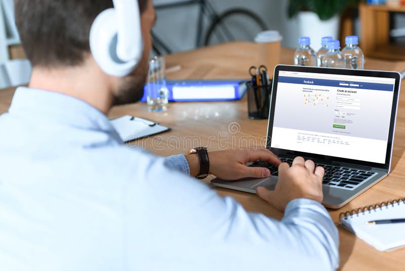 businessman using laptop with loaded facebook page. businessman using laptop with loaded facebook page