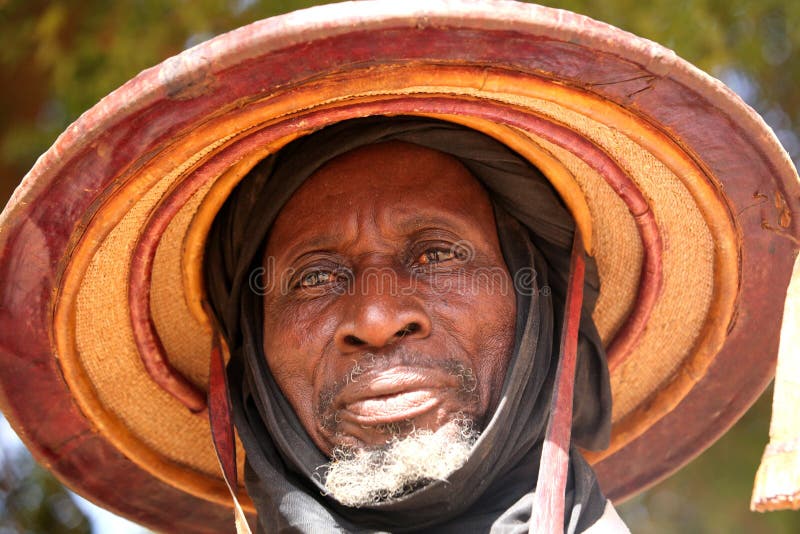 Fulani man with a traditional hat at a wedding ceremony in january in Dogon valley. Fulani man with a traditional hat at a wedding ceremony in january in Dogon valley