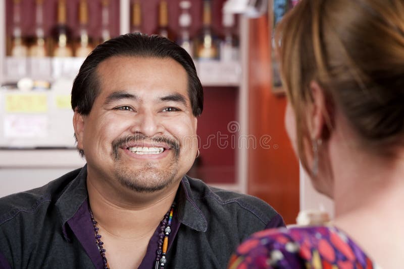 Handsome Native American man with female friend in a restaurant. Handsome Native American man with female friend in a restaurant