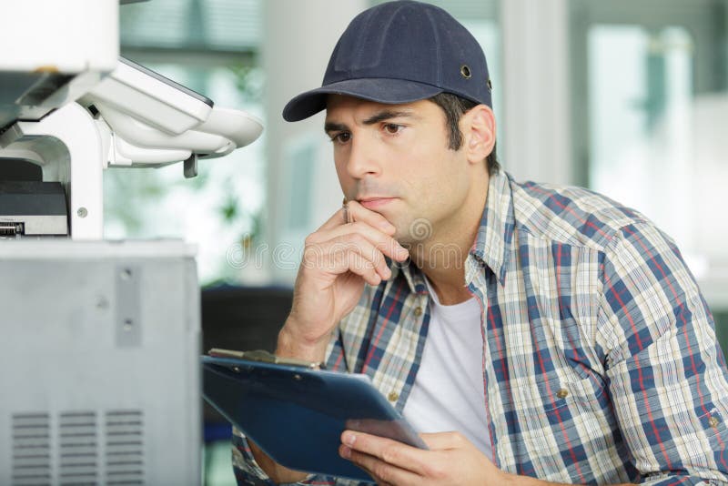 A man during printer repair assistance. A man during printer repair assistance