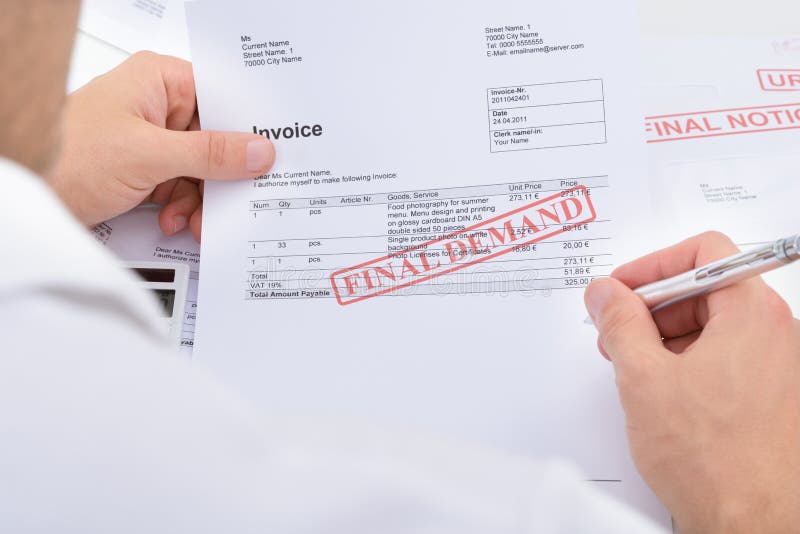 Close-up Of A Man Holding Invoice With Final Demand Notification And Pen. Close-up Of A Man Holding Invoice With Final Demand Notification And Pen