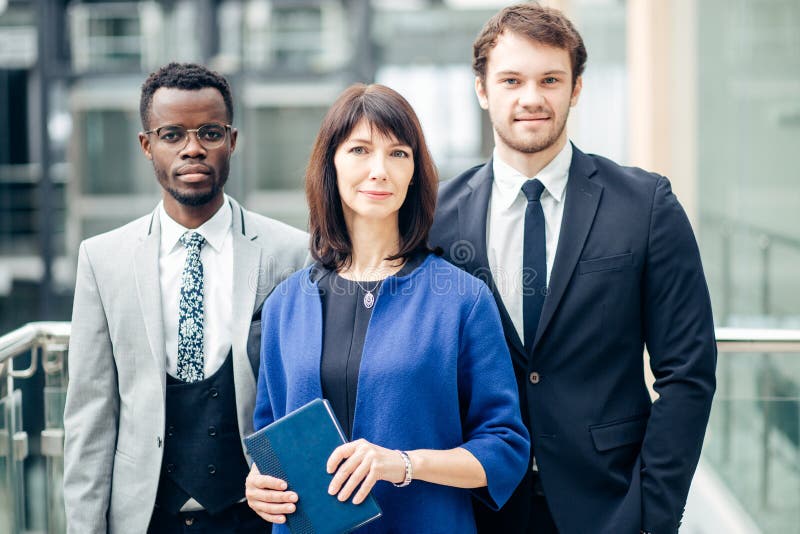 Hommes d'affaires réussis d'arbre, équipe d'affaires posant dans le bureau moderne images stock Hommes d'affaires réussis d'arbre, équipe d'affaires posant dans le bureau moderne images stock