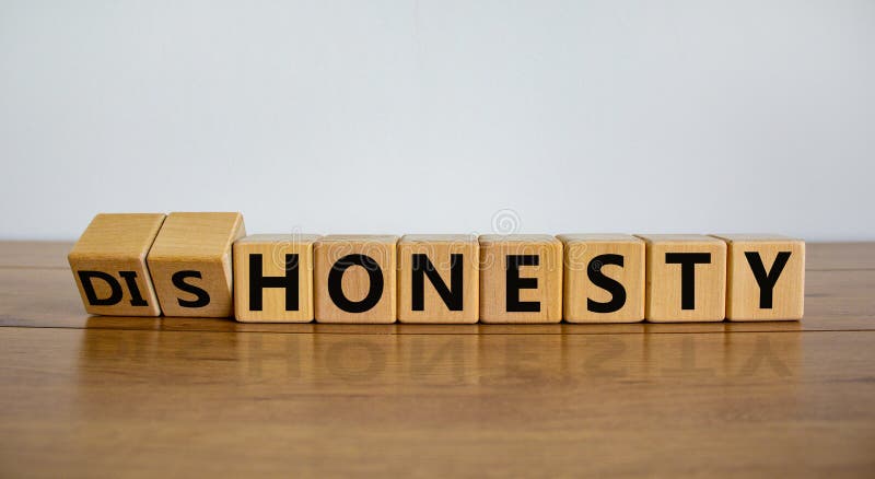 Honesty or dishonesty symbol. Turned cube and changed the word `dishonesty` to `honesty`. Beautiful wooden table, white backgr royalty free stock photo