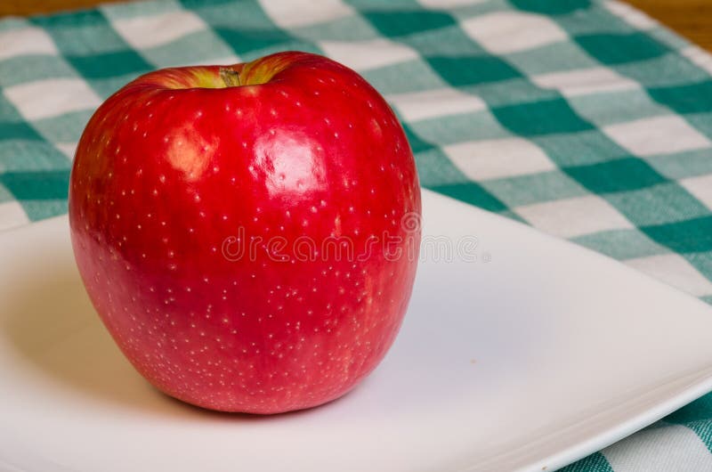 Honey Crisp apple on a white plate