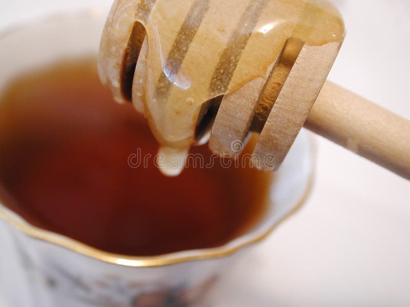 Honey dripping into tea