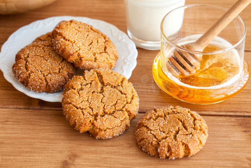 Honey ginger cookies with milk on a rustic background