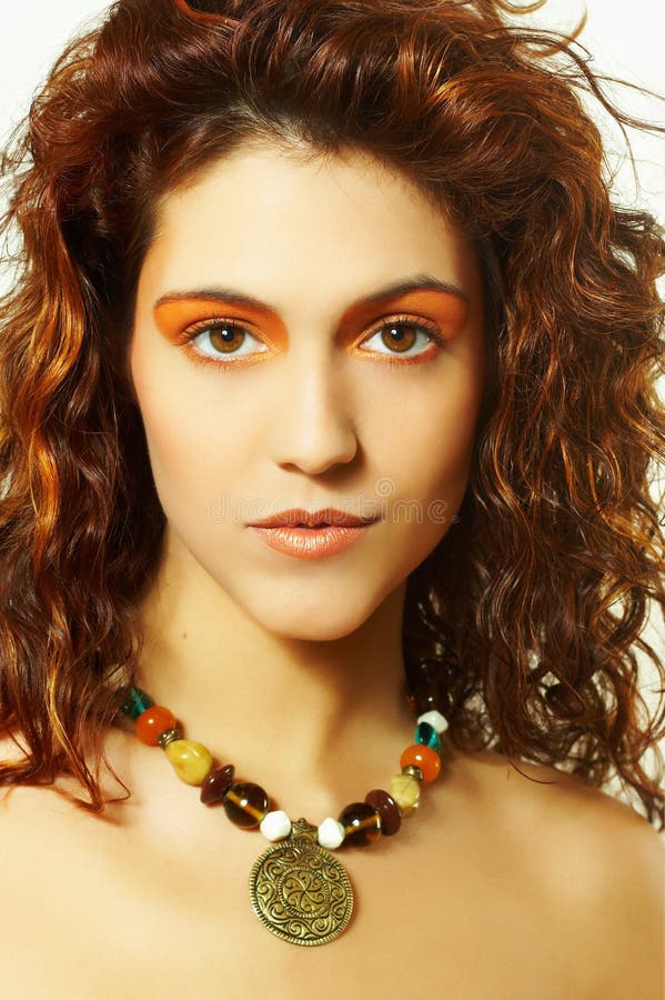 Portrait of the girl with twisted dark hair. On a neck at it a necklace from stones. Lovely european female stock images, royalty-free photos and pictures