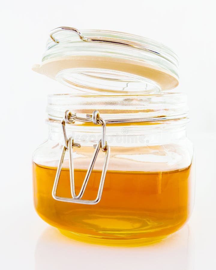 Clear honey in glass jar stock image. Image of close 54411413