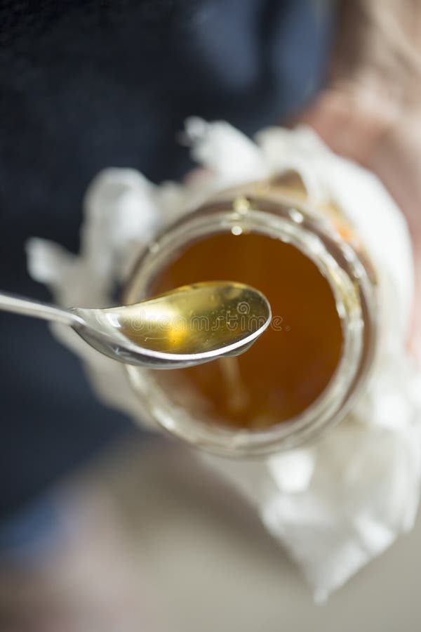Honey in jar spoon, hands. stock image. Image of isolated 212330303