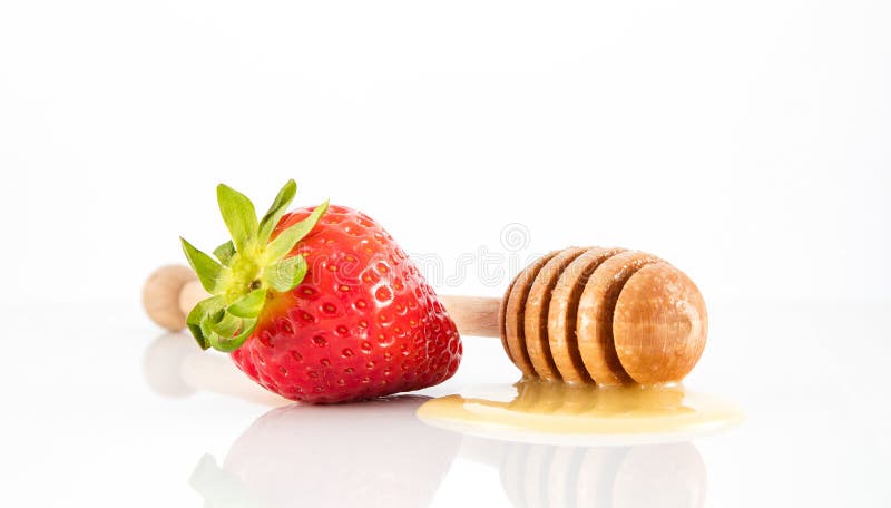 Honey on stick with strawberry