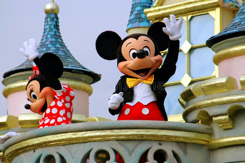 Hong Kong, China: Disney stalwarts Mickey and Minnie Mouse riding on a float in the Grand Parade on Main Street waving to Disneyland visitors. Hong Kong, China: Disney stalwarts Mickey and Minnie Mouse riding on a float in the Grand Parade on Main Street waving to Disneyland visitors