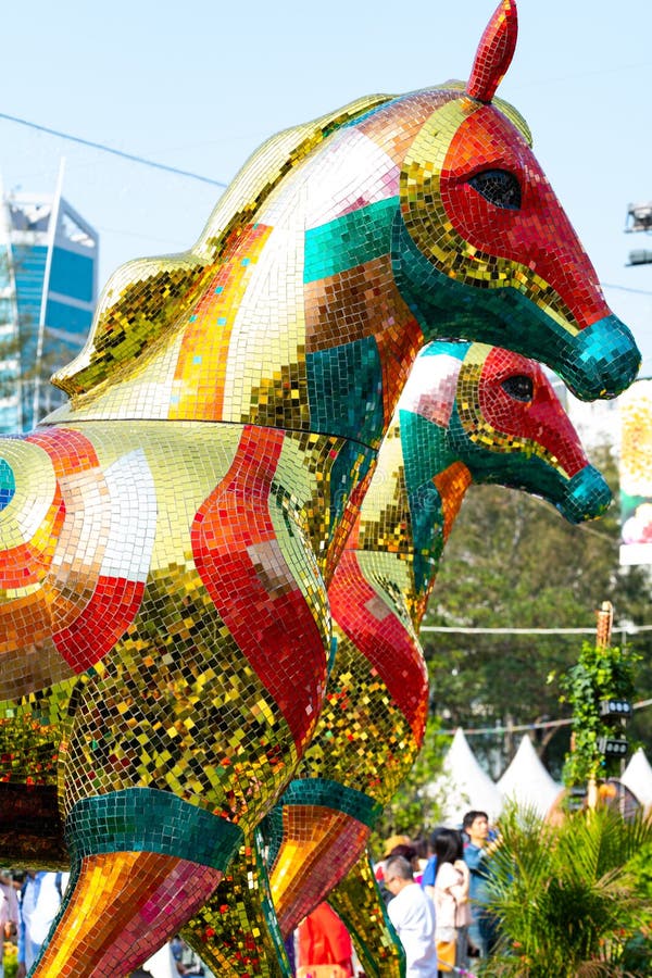 Hong Kong, China - March 18th 2018 : Majestic model horses made of shiny colourful chip tiles, front torso clicked in bright sunshine, on display at the Hong Kong Flower Show 2018. Hong Kong, China - March 18th 2018 : Majestic model horses made of shiny colourful chip tiles, front torso clicked in bright sunshine, on display at the Hong Kong Flower Show 2018.