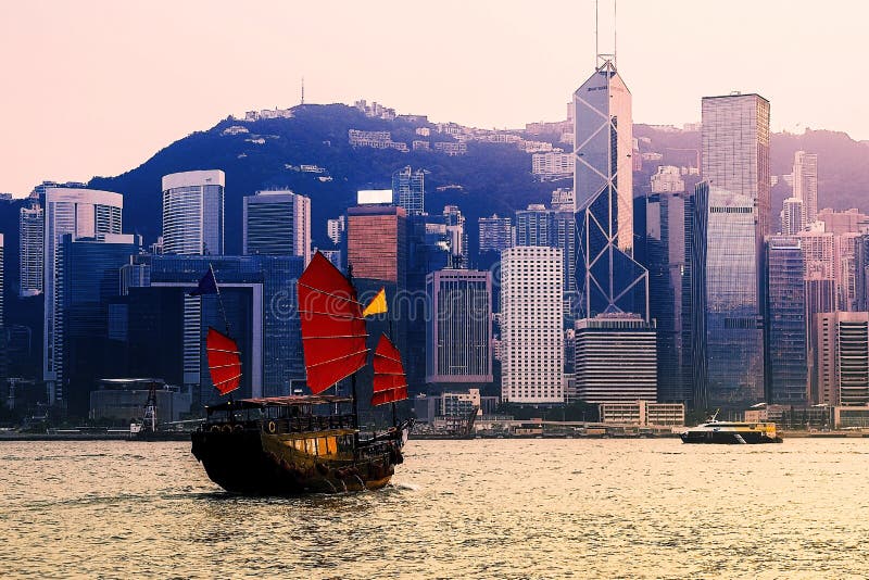 Hong Kong Cityscape at Victoria Harbour and Tourist Junk Boat Stock