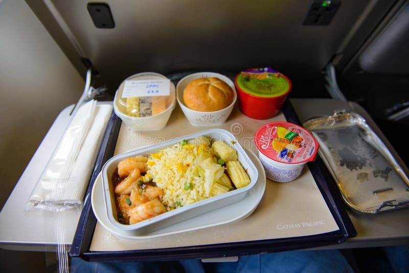 Hong Kong, Hong Kong - August 8, 2015 : Cathay Pacific food served on board of economy class airplane on the table royalty free stock photos Hong Kong, Hong Kong - August 8, 2015 : Cathay Pacific food served on board of economy class airplane on the table royalty free stock photos