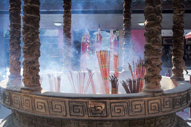 Hong Kong : November 20, 2019 - Closeup group of incenses put in the brass ashtray with smoke in the air at Wong Ta Sin temple. royalty free stock photos Hong Kong : November 20, 2019 - Closeup group of incenses put in the brass ashtray with smoke in the air at Wong Ta Sin temple. royalty free stock photos