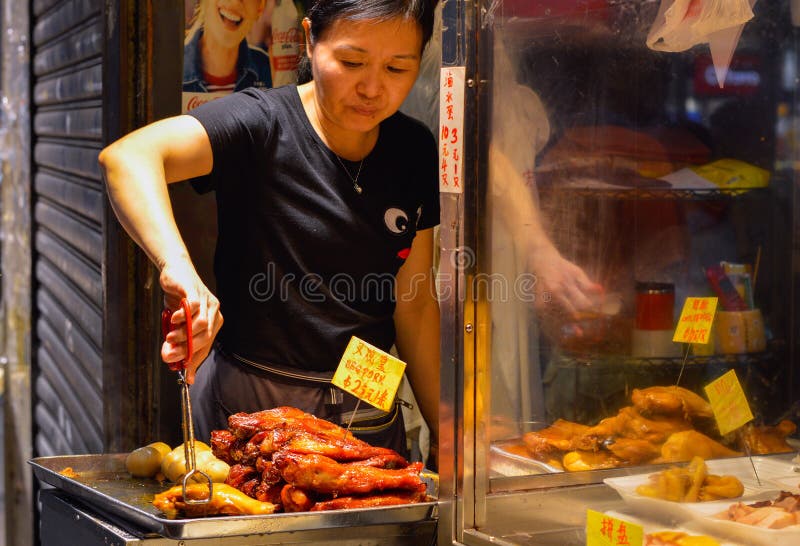Hong Kong, August, 2018. Street Food Vendor Selling BBQ Pork in the Night. Hong Kong, August, 2018. Street Food Vendor Selling BBQ Pork in the Night.