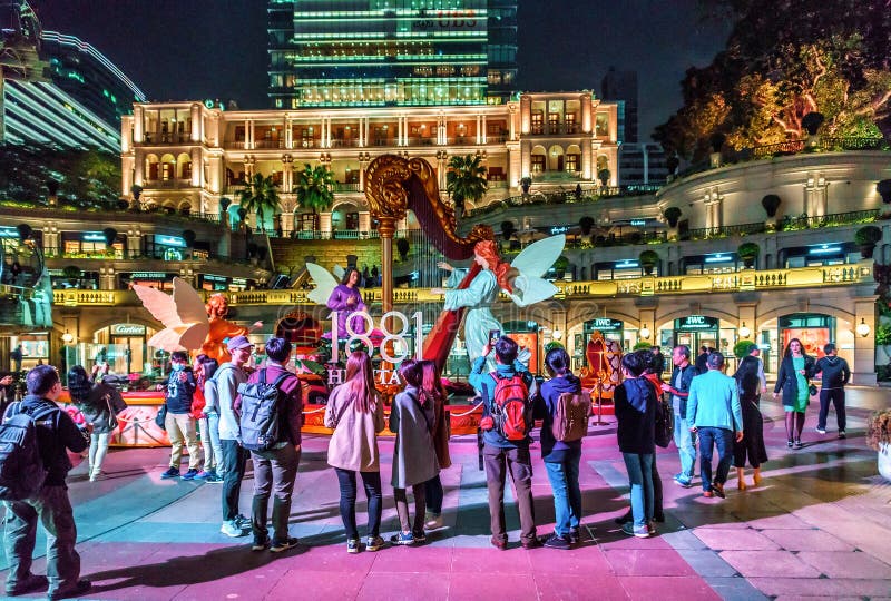 Hong Kong - Tourists standing at Christian festive decorations on Chinese New Year celebration by the iconic stock image Hong Kong - Tourists standing at Christian festive decorations on Chinese New Year celebration by the iconic stock image