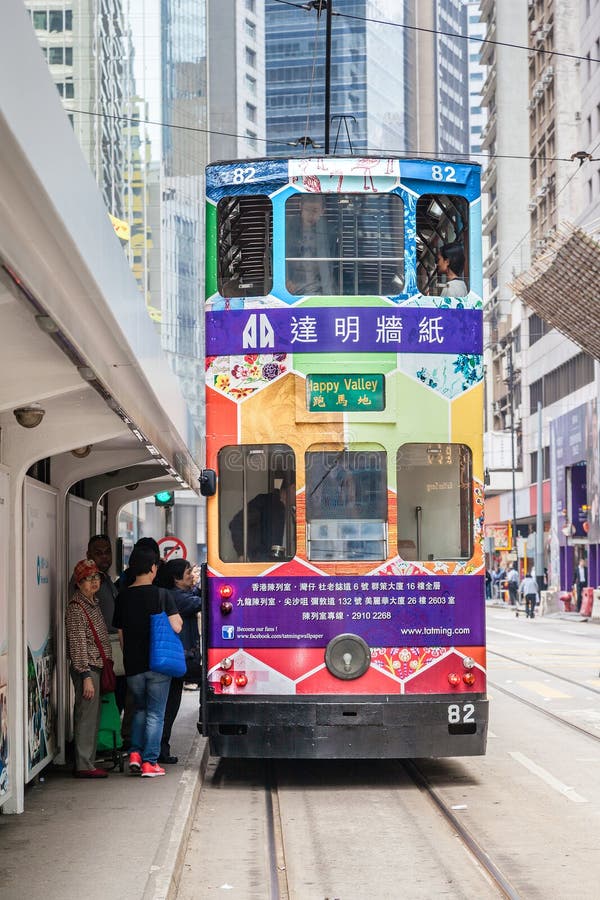 Passengers board an electric tram on Des Voeux Road in the downtown Central District of Hong Kong. These historic streetcars have been in operation since 1904. It is the world's only tram system that operates exclusively with double-decker trams. Passengers board an electric tram on Des Voeux Road in the downtown Central District of Hong Kong. These historic streetcars have been in operation since 1904. It is the world's only tram system that operates exclusively with double-decker trams.