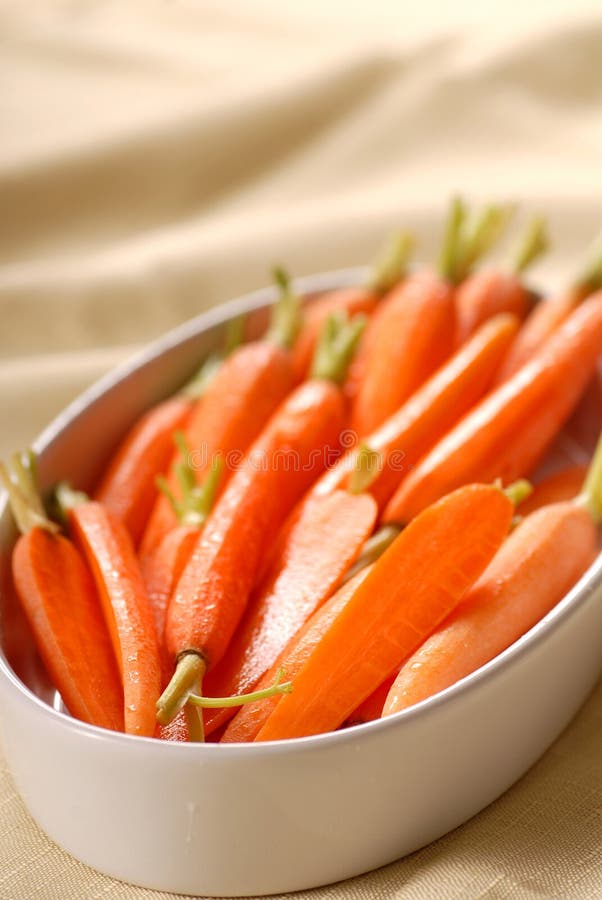 Fresh organic honey glazed baby carrots in a serving bowl. Fresh organic honey glazed baby carrots in a serving bowl