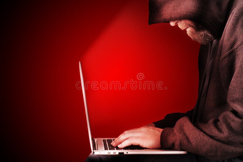 Hooded computer hacker red background stock images