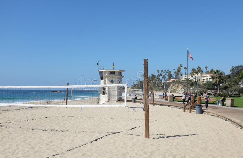 LAGUNA BEACH, CALIFORNIA - OCTOBER 3, 2016: Main Beach. Sand volleyball court, Lifeguard Station and boardwalk are just three of the many attractions along the Laguna Coastline. LAGUNA BEACH, CALIFORNIA - OCTOBER 3, 2016: Main Beach. Sand volleyball court, Lifeguard Station and boardwalk are just three of the many attractions along the Laguna Coastline.