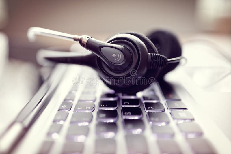 Hoofdtelefoon op een laptop computertoetsenbord Hoofdtelefoon op een laptop computertoetsenbord