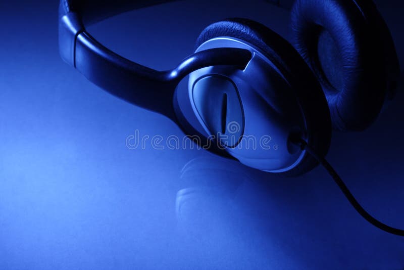 Headphones on glass table in blue light. Headphones on glass table in blue light