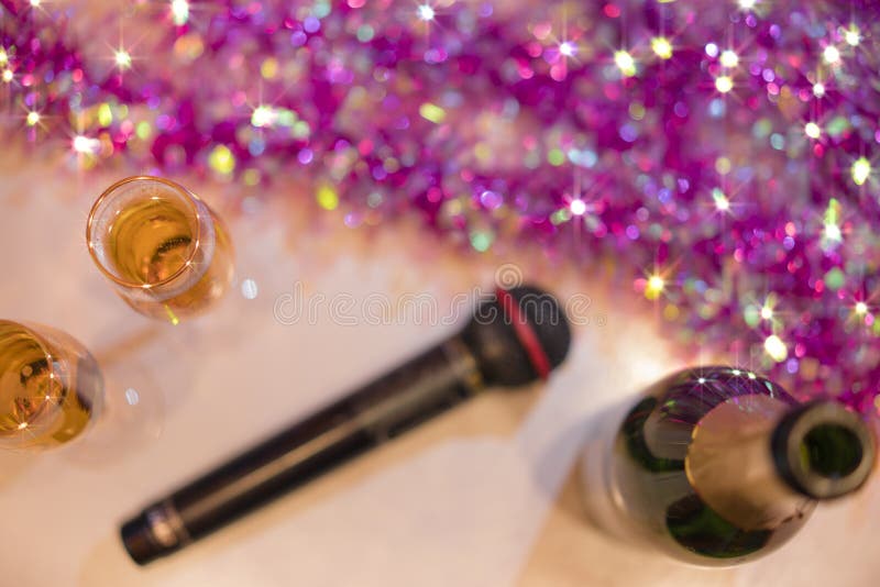 Hoogste mening van romantisch paar van champagnefluiten en fles mousserende wijn met zwarte karaokemicrofoon en roze slinger stock foto Hoogste mening van romantisch paar van champagnefluiten en fles mousserende wijn met zwarte karaokemicrofoon en roze slinger stock foto