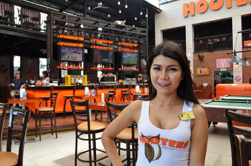 Hooters girl poses for photo in Hooters restaurant