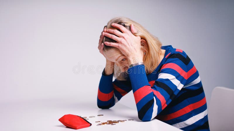 hopeless elderly woman looking at the empty wallet. High quality photo