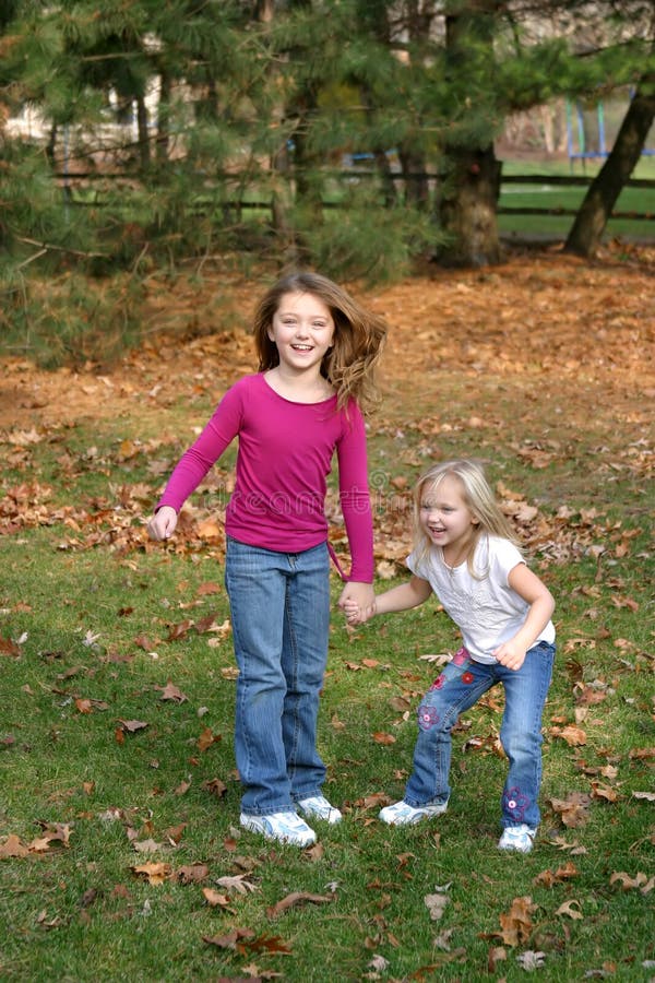2 little girls playing outside in forest. 2 little girls playing outside in forest