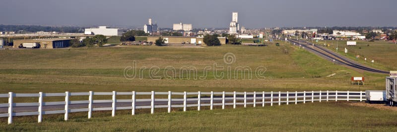 Grain elevators rise above the low skyline of Dodge City, Kansas, as seen looking west at sunrise. Grain elevators rise above the low skyline of Dodge City, Kansas, as seen looking west at sunrise