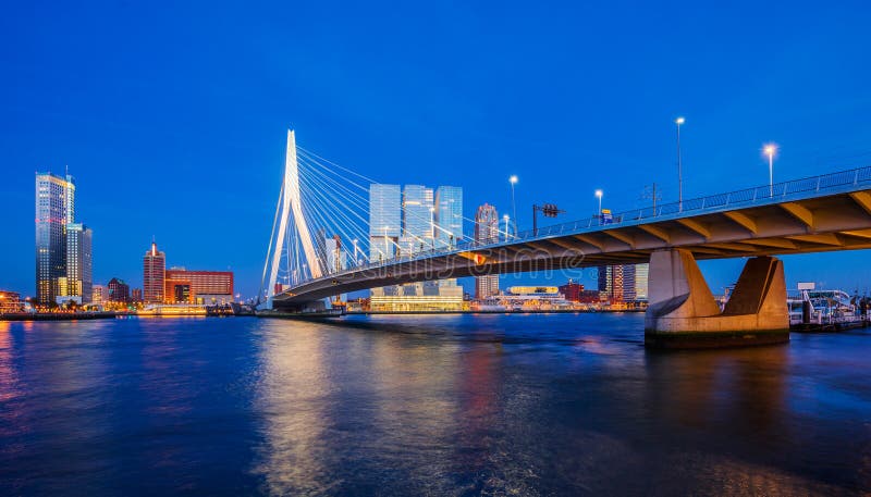 Erasmus bridge and modern buildings at twilight in Rotterdam, The Netherlands. Erasmus bridge and modern buildings at twilight in Rotterdam, The Netherlands