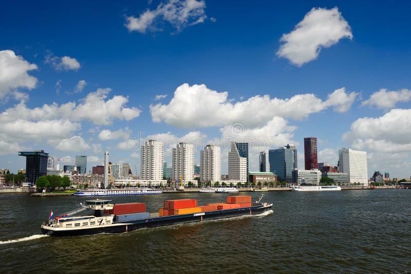 Rotterdam skyline and a container ship on the meuse river the Netherlands, Europe. Rotterdam skyline and a container ship on the meuse river the Netherlands, Europe