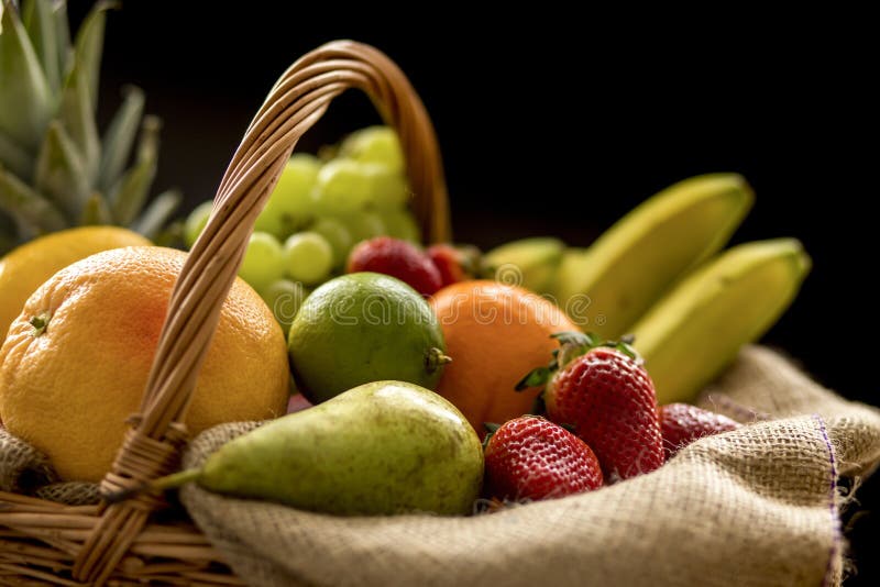 Horizontal Closeup detail on a basket full of fruit on a dark background stock photo Horizontal Closeup detail on a basket full of fruit on a dark background stock photo